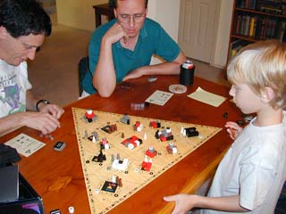 Cliff and Mark see 7 year old Kevin play a mean game of Tal der Koenige.